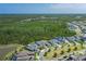 Aerial view of gated community homes backing to Florida nature preserve with lake views at 16557 Acoustic Loop, Land O Lakes, FL 34638