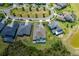 Aerial view of home with screened pool and lake backing to home at 16557 Acoustic Loop, Land O Lakes, FL 34638