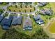 Aerial view of a home with a screened-in pool, surrounded by lush greenery at 16557 Acoustic Loop, Land O Lakes, FL 34638