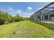 Expansive backyard with a well-manicured lawn and a screened-in pool area for outdoor enjoyment at 16557 Acoustic Loop, Land O Lakes, FL 34638