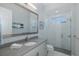 Modern bathroom features glass shower, light gray cabinets, and elegant finishes at 16557 Acoustic Loop, Land O Lakes, FL 34638