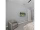Comfortable bedroom features a mounted television and an armchair at 16557 Acoustic Loop, Land O Lakes, FL 34638