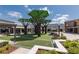 Outdoor common area with shaded seating, lush green turf, and inviting landscaping within the commercial plaza at 16557 Acoustic Loop, Land O Lakes, FL 34638