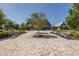 Community gathering area with benches, sidewalks, and a central tree at 16557 Acoustic Loop, Land O Lakes, FL 34638