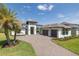 Beautiful home with a three-car garage, meticulous landscaping, and a grand entrance at 16557 Acoustic Loop, Land O Lakes, FL 34638