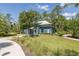 Exterior of a fitness center with sidewalk access, landscaping, and a metal roof at 16557 Acoustic Loop, Land O Lakes, FL 34638