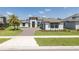 Stately two-story house with a brick driveway, beautiful landscaping, and a well-manicured lawn at 16557 Acoustic Loop, Land O Lakes, FL 34638