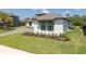 Front yard features lush lawn, modern home, and manicured landscaping at 16557 Acoustic Loop, Land O Lakes, FL 34638