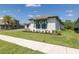 Beautifully landscaped front yard with lush green lawn and modern home exterior at 16557 Acoustic Loop, Land O Lakes, FL 34638