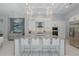 Modern kitchen features a large island with seating, stainless steel appliances, and elegant pendant lighting at 16557 Acoustic Loop, Land O Lakes, FL 34638