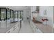 Modern kitchen featuring gray countertops, stainless steel appliances, and a view of the outdoor pool area at 16557 Acoustic Loop, Land O Lakes, FL 34638