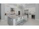 Bright kitchen with stainless steel appliances, a large island with seating, and modern pendant lighting fixtures at 16557 Acoustic Loop, Land O Lakes, FL 34638