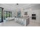 Spacious open-concept kitchen with island seating, stainless steel appliances, and a view to the dining and living area at 16557 Acoustic Loop, Land O Lakes, FL 34638