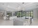 Open-concept kitchen featuring a large island with seating, stainless steel appliances, and a seamless flow to the living area at 16557 Acoustic Loop, Land O Lakes, FL 34638