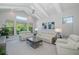 Spacious living room with high ceilings, modern furniture, and plenty of natural light at 16557 Acoustic Loop, Land O Lakes, FL 34638