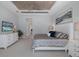Comfortable main bedroom featuring gray hues, decorative ceiling, and a view into the hall at 16557 Acoustic Loop, Land O Lakes, FL 34638