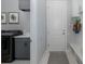 Mudroom features a gray washer and dryer and a convenient bench at 16557 Acoustic Loop, Land O Lakes, FL 34638