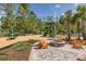 Community playground featuring modern play structures, a fire pit, and comfortable seating for families to enjoy at 16557 Acoustic Loop, Land O Lakes, FL 34638