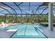 Inviting screened-in pool area with a spa, water features, and ample lounging space at 16557 Acoustic Loop, Land O Lakes, FL 34638