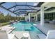 Relaxing pool area with a spa, seating, and an outdoor dining area at 16557 Acoustic Loop, Land O Lakes, FL 34638