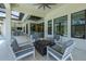 Relaxing screened-in lanai featuring a fire pit and comfortable seating, perfect for outdoor gatherings at 16557 Acoustic Loop, Land O Lakes, FL 34638