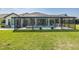 The property has a beautiful screened-in pool and patio, with a well-maintained lawn at 16557 Acoustic Loop, Land O Lakes, FL 34638