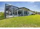 The house features a screened-in pool and patio area, complemented by a lush green lawn at 16557 Acoustic Loop, Land O Lakes, FL 34638