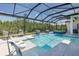 Relax by the pool in this screened-in lanai with tranquil water features and comfortable seating at 16557 Acoustic Loop, Land O Lakes, FL 34638