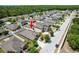 An aerial view of a property showcasing mature trees, landscaping, and neighborhood layout at 18353 Briar Oaks Dr, Hudson, FL 34667