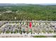 Aerial view of a property in a community with mature trees and landscaping in background at 18353 Briar Oaks Dr, Hudson, FL 34667