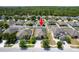 Front aerial view of property showcasing proximity to neighboring homes, landscaping, and nearby trees at 18353 Briar Oaks Dr, Hudson, FL 34667
