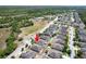 Aerial view of property, mature trees in neighborhood, and nearby highway at 18353 Briar Oaks Dr, Hudson, FL 34667