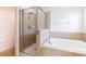 Bathroom featuring a glass shower, soaking tub and tile at 18353 Briar Oaks Dr, Hudson, FL 34667