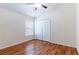 Bedroom with hardwood floors, ceiling fan, and closet at 18353 Briar Oaks Dr, Hudson, FL 34667