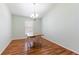 Eat-in dining room features chandelier, wood floors, and natural light at 18353 Briar Oaks Dr, Hudson, FL 34667