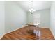 Eat-in dining room features chandelier, wood floors, and natural light at 18353 Briar Oaks Dr, Hudson, FL 34667