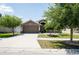 Beautiful home with a large driveway, mature trees, and well-maintained lawn providing a welcoming atmosphere at 18353 Briar Oaks Dr, Hudson, FL 34667