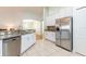 Bright kitchen with granite countertops, stainless steel appliances, and white cabinetry at 18353 Briar Oaks Dr, Hudson, FL 34667