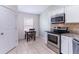 Kitchen area featuring a table, stainless steel appliances, and ample cabinet space at 18353 Briar Oaks Dr, Hudson, FL 34667