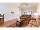 Comfortable living room with a sliding glass door, wood floors, and a cozy seating arrangement, perfect for relaxation at 18353 Briar Oaks Dr, Hudson, FL 34667