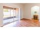 Living room featuring hardwood floors and a large glass sliding door to the outside at 18353 Briar Oaks Dr, Hudson, FL 34667