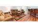 Spacious living room features hardwood floors, an area rug, and comfortable seating, creating a cozy atmosphere at 18353 Briar Oaks Dr, Hudson, FL 34667