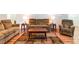 Warm and inviting living room features hardwood floors, comfortable seating, and plenty of space for entertaining guests at 18353 Briar Oaks Dr, Hudson, FL 34667