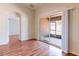 Open living room featuring laminate wood flooring and sliding glass doors to screened porch at 18353 Briar Oaks Dr, Hudson, FL 34667