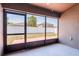 Screened patio with exterior view to the backyard and white vinyl fence at 18353 Briar Oaks Dr, Hudson, FL 34667