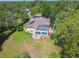 Overhead view of a private retreat nestled among the trees, complete with a screened pool area, solar panels, and large yard at 18502 Winding Oaks Blvd, Hudson, FL 34667