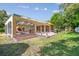 Screened-in lanai with patio, pool, and lush backyard; perfect for outdoor living and entertaining at 18502 Winding Oaks Blvd, Hudson, FL 34667