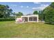 Spacious backyard with a screened lanai, patio seating, and ample green space at 18502 Winding Oaks Blvd, Hudson, FL 34667