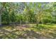 Fenced area in the backyard with a gate, providing a secure and private space at 18502 Winding Oaks Blvd, Hudson, FL 34667