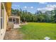 Expansive backyard with a screen enclosed patio and lush lawn, perfect for outdoor entertaining at 18502 Winding Oaks Blvd, Hudson, FL 34667